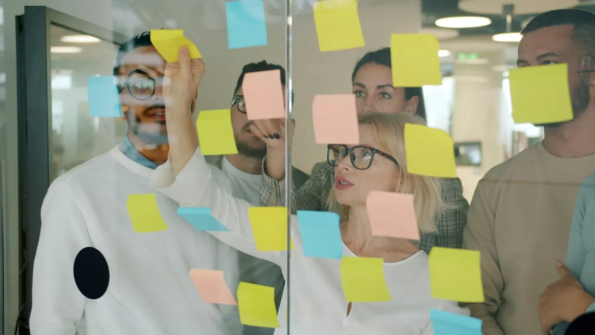 Team mapping a business process with sticky notes
