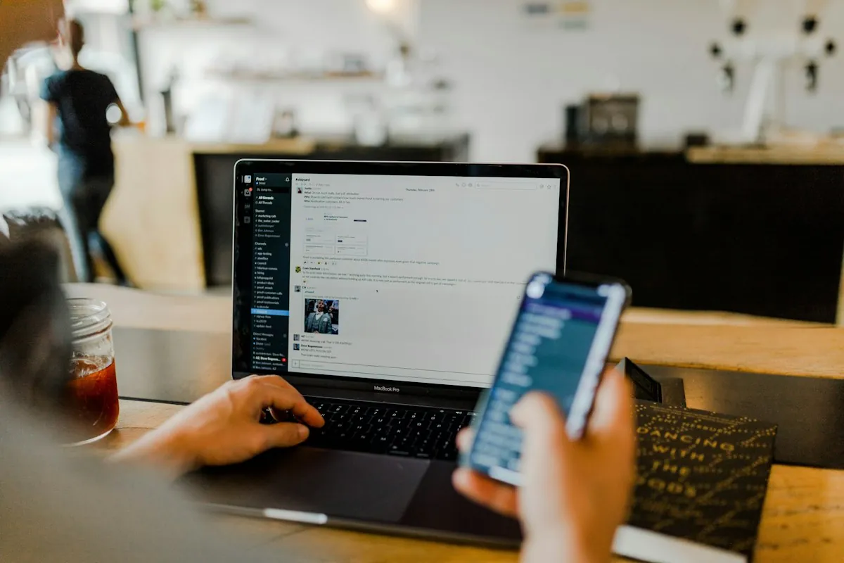 Person using business software on a laptop and phone