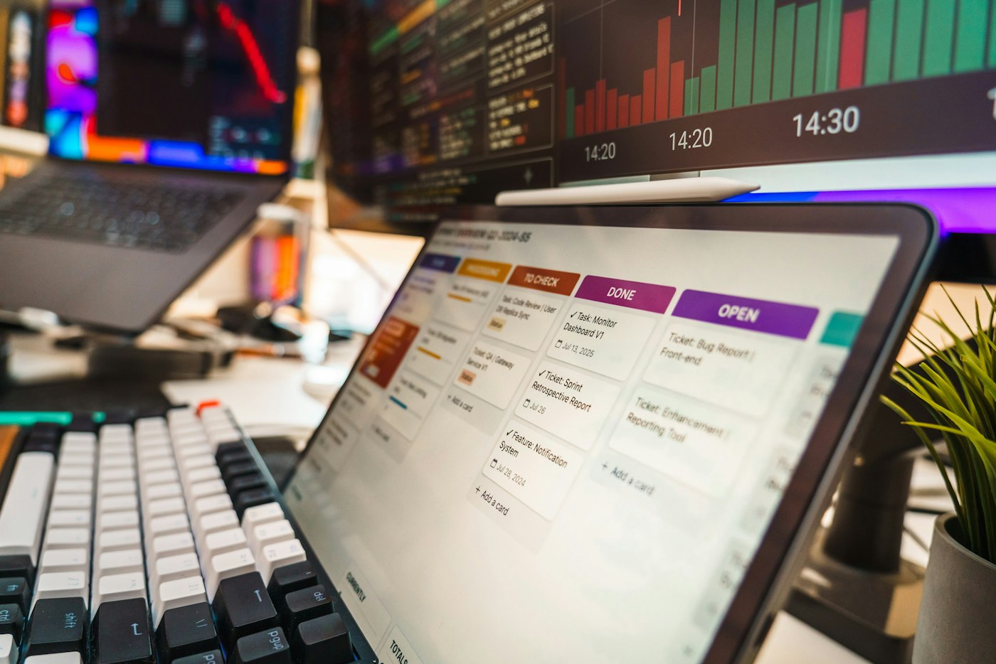 Tablet showing a workflow task board with status columns on a business desk